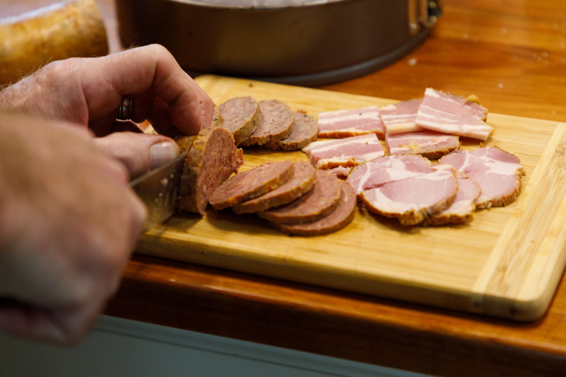 Slicing house-cured meats and bacon on the board